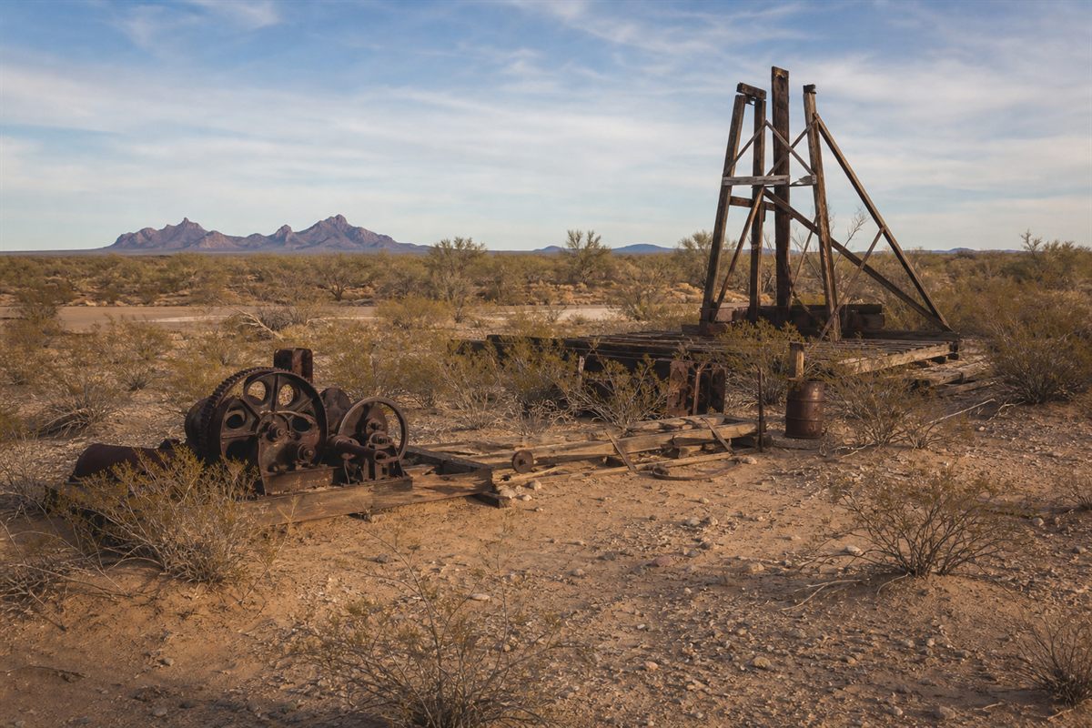 Rusted remains of the original 1928 drilling rig lying in the desert west of the Hot Well Dunes entrance road